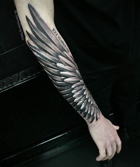 angel with wing tattoo|angel wings tattoo on forearm.